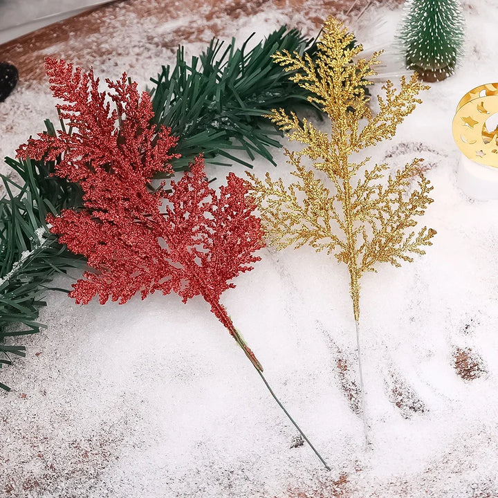 Artificial glittery pine branches on tree