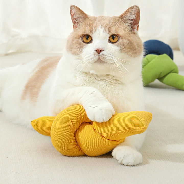 Cat playing with a yellow knitted toy