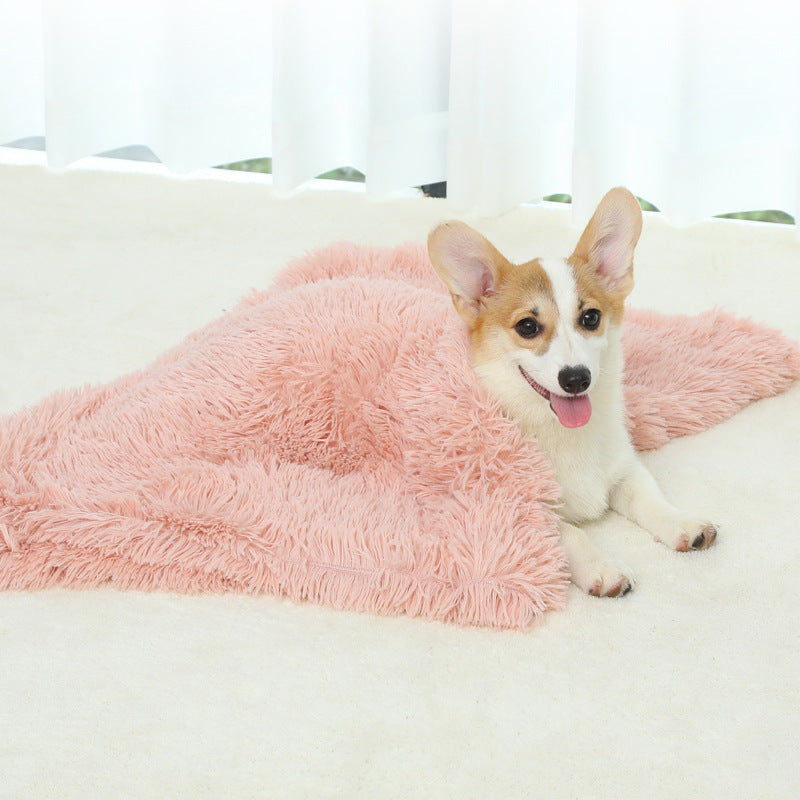 Dog lying on a fluffy pink blanket