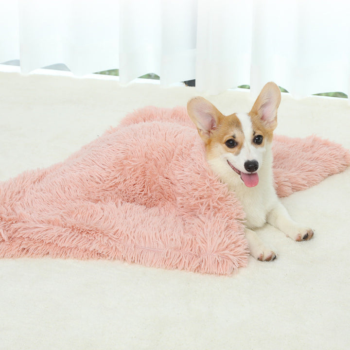 Dog lying on a fluffy pink blanket