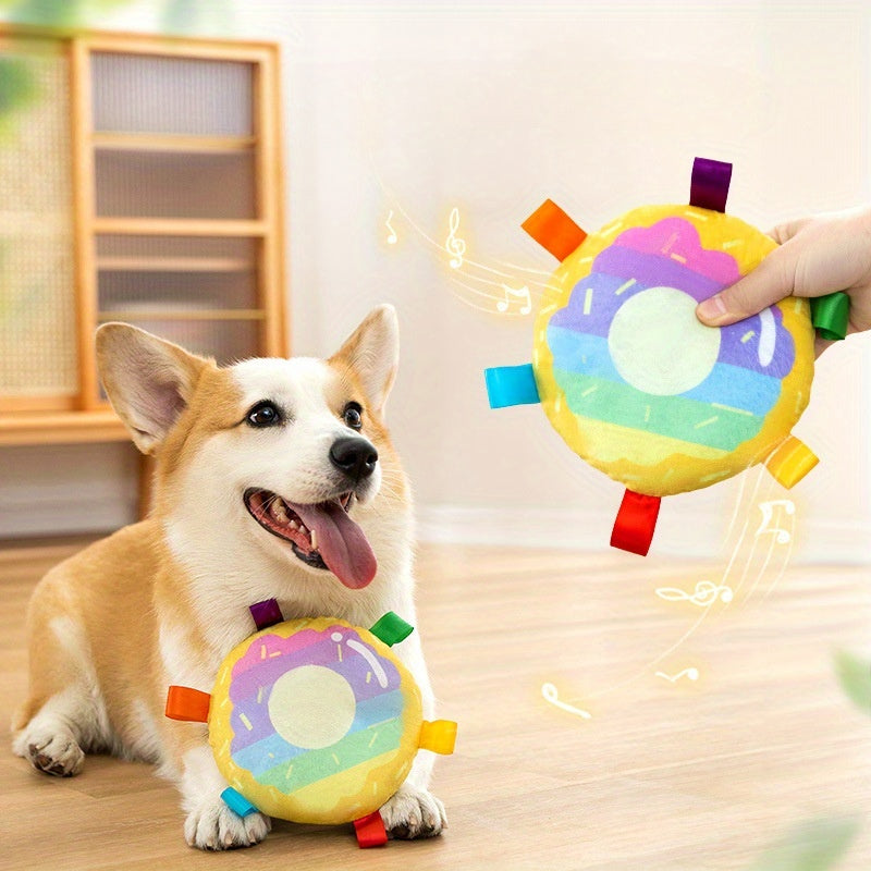 Dog playing with a colorful toy held by a hand