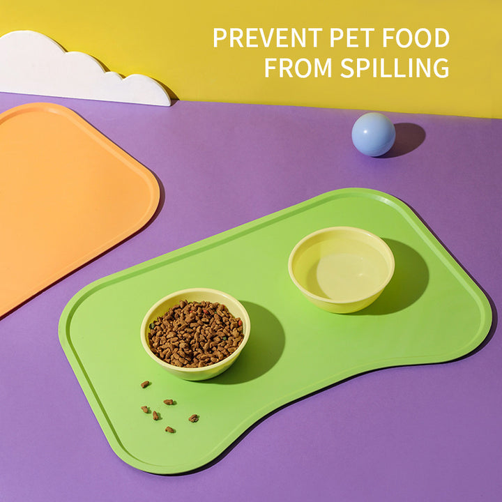 Green pet mat with two bowls on a purple surface