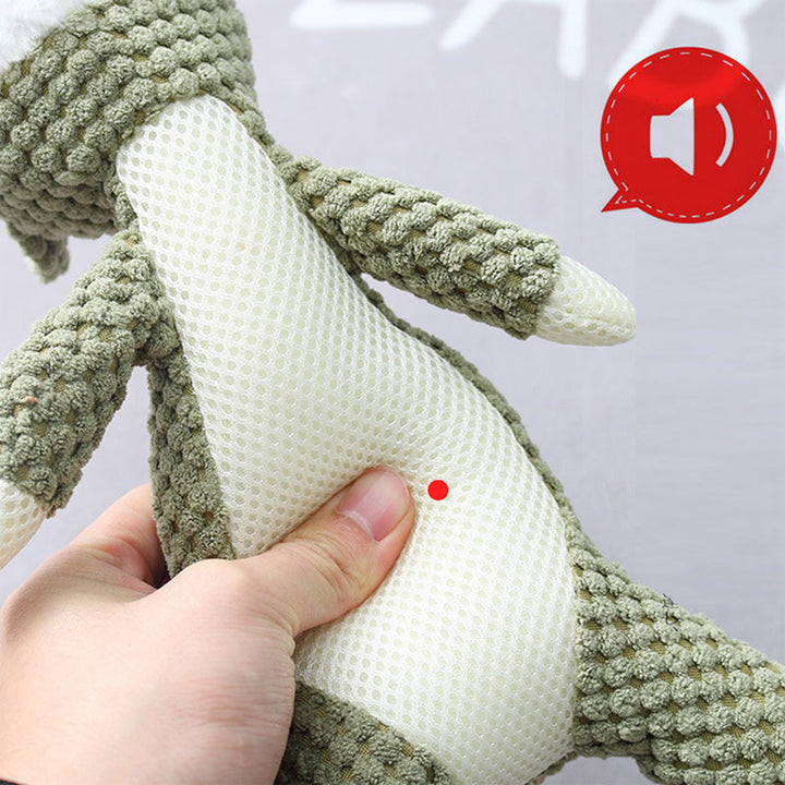Hand holding a green knitted toy 