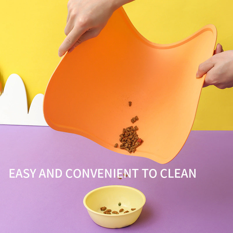 Orange silicone mat with pet food on a purple surface