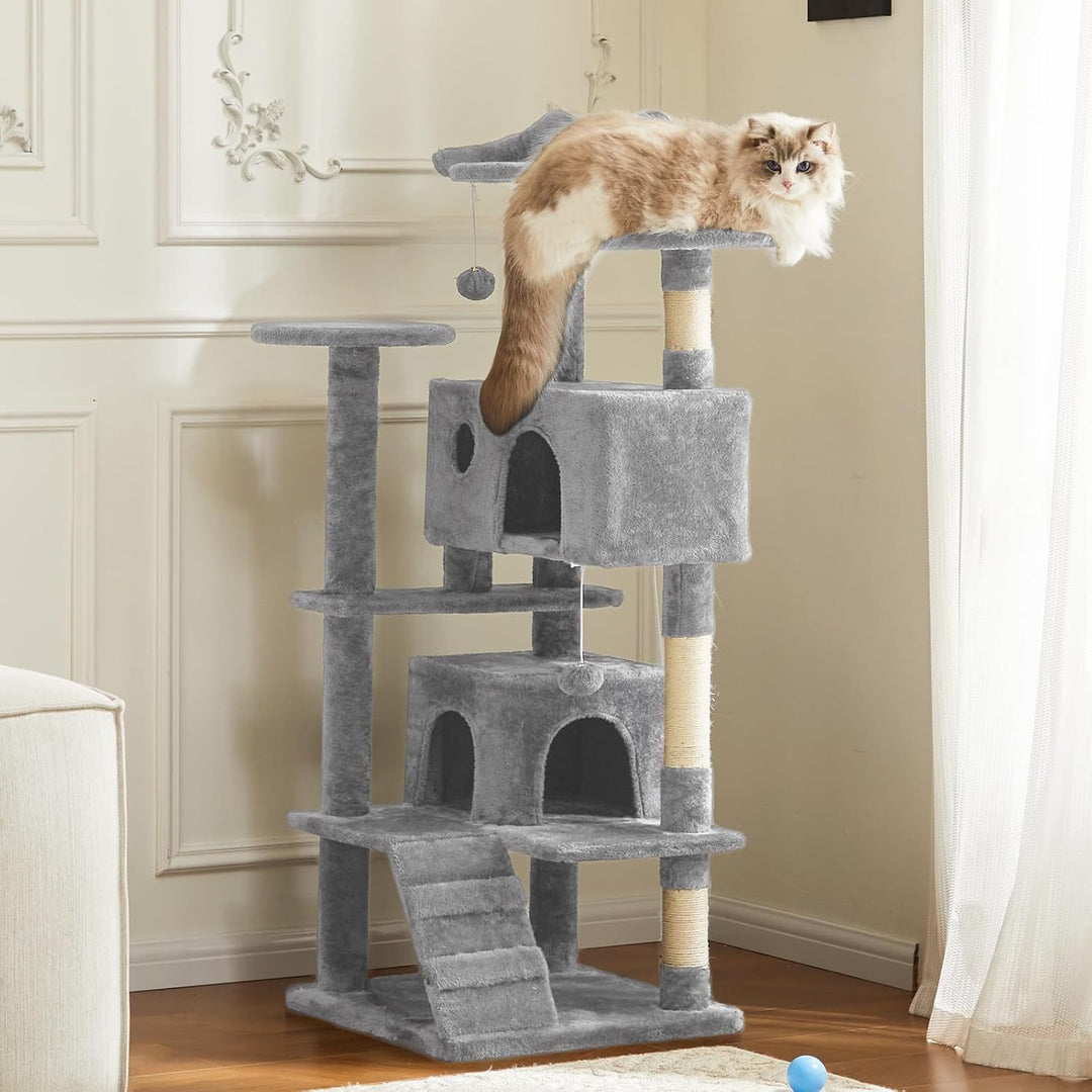 Cat sitting on a gray cat tree in a room