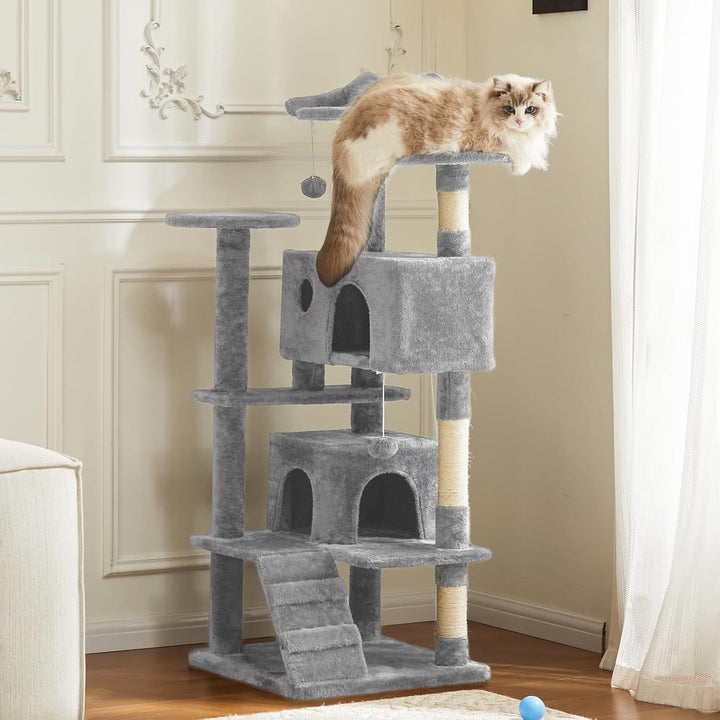Cat sitting on a gray cat tree in a room