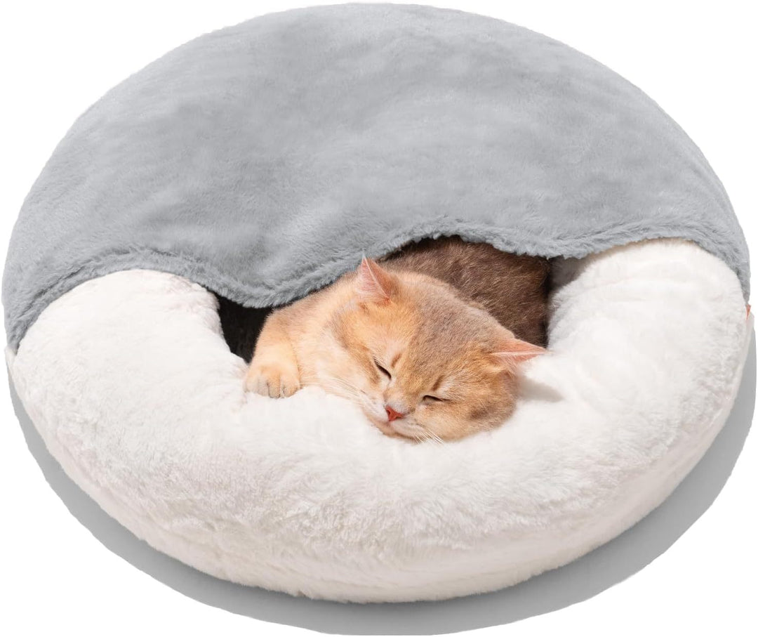 Cat sleeping in a round, plush pet bed
