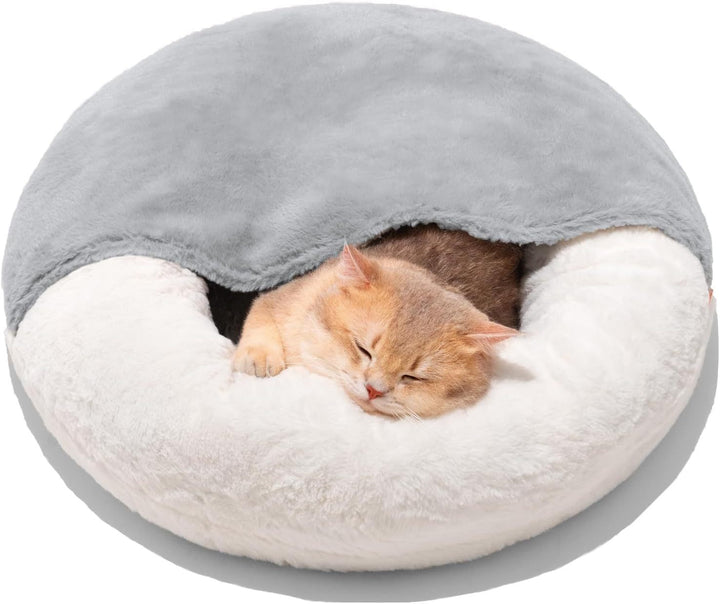 Cat sleeping in a round, plush pet bed
